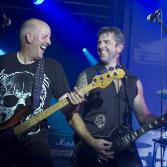 Richard and Alan playing on stage and laughing.