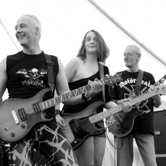 Neil, Ann and Rocker, all with guitars, smiling (black and white).