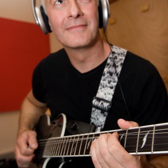 Close up of Neil playing in the studio.