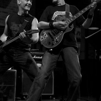 Neil and Rocker smiling at each other, in black and white.