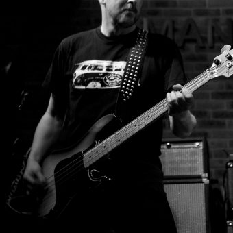 Richard playing bass, in black and white.