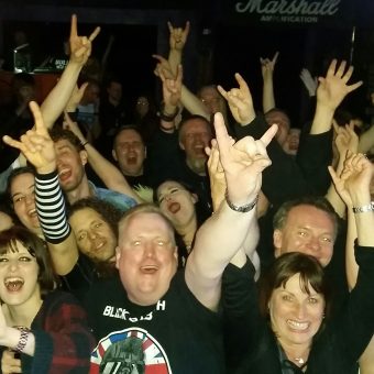 The crowd at Sanctuary Rock Bar, Burnley, cheering and waving their arms.