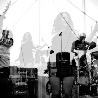 The band performing, multi-layered effect, black and white.