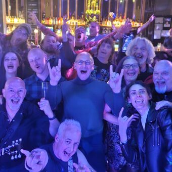 The crowd at the Brickhouse Tavern in St Helens, as seen from the stage. Everyone is smiling, cheering and throwing their finest rock horns. Guitarists John and Neil have also photobombed the pic.